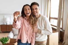 Happy couple with keys to their first home.